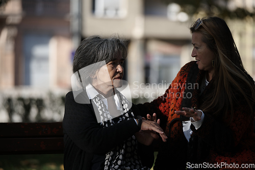 Image of Elderly old cute woman with Alzheimer's very happy and smiling when eldest daughter hugs and takes care of her