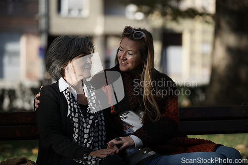 Image of Elderly old cute woman with Alzheimer's very happy and smiling when eldest daughter hugs and takes care of her