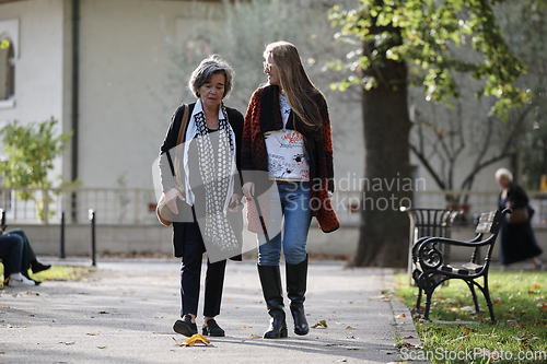 Image of Elderly old cute woman with Alzheimer's very happy and smiling when eldest daughter hugs and takes care of her