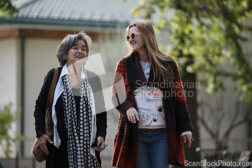 Image of Elderly old cute woman with Alzheimer's very happy and smiling when eldest daughter hugs and takes care of her