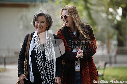 Image of Elderly old cute woman with Alzheimer's very happy and smiling when eldest daughter hugs and takes care of her