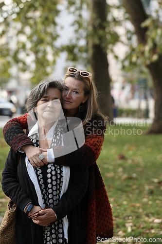 Image of Elderly old cute woman with Alzheimer's very happy and smiling when eldest daughter hugs and takes care of her