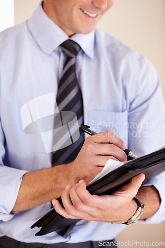 Image of Hands, writing and paperwork for business man, smile and thinking with notes, schedule or ideas in workplace. Entrepreneur, accountant and documents with pen, brainstorming and checklist in office