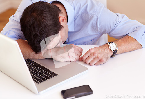 Image of Business man, sleep and laptop at desk in office with fatigue, frustrated or tired for stress in workplace. Accountant, computer and burnout with smartphone, exhausted or overtime at financial agency