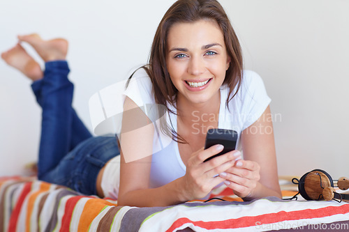 Image of Smile, bed and girl in morning with phone, checking email or social media post in home weekend. Relax, rest and communication, happy woman with smartphone and scroll in apartment, house or bedroom.