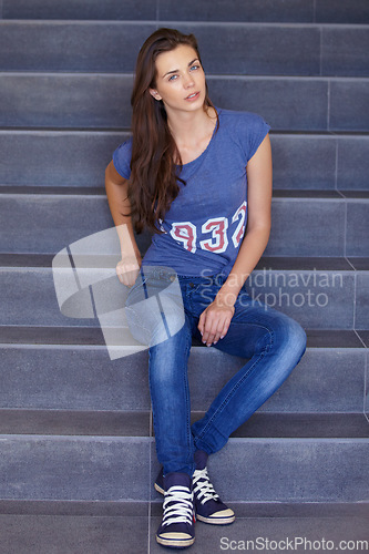 Image of Portrait, stairs and woman with fashion, casual and relax with stylish outfit, weekend break and chilling. Person, human and girl on sitting on steps, jeans and streetwear with wellness and aesthetic