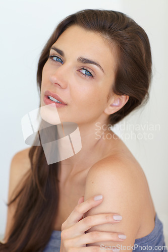 Image of Portrait, beauty and cosmetics with a natural woman in studio on a white background for skincare or wellness. Face, manicure and hair with a confident young model at the salon for glow or shine