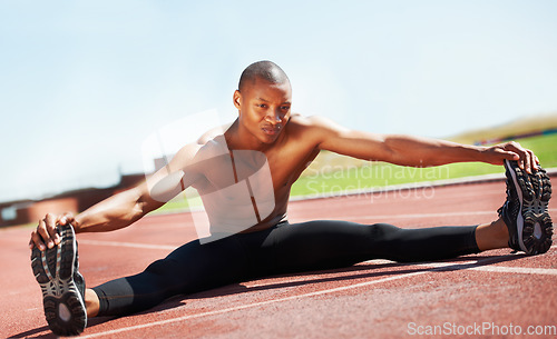 Image of Man, athlete and stretching legs on floor, outdoors and fitness for health, sports and performance. Black male person, ready and warmup on track, workout and commitment in training, start and cardio