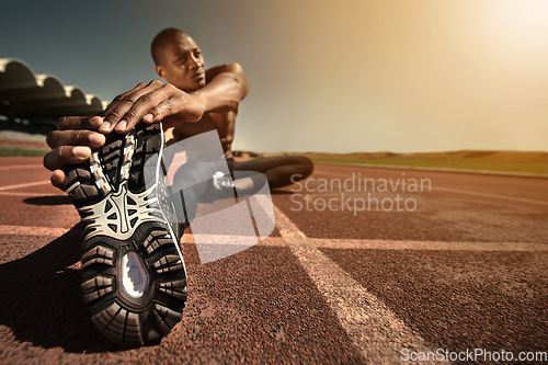 Image of Man, shoes and stretching leg on ground, sunset and fitness for health, sports and performance. Black male person, athlete and warmup on track, workout and commitment or ready, train and outdoors