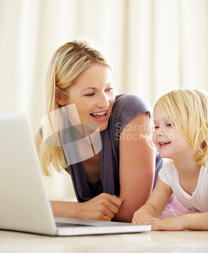 Image of Online, learning and mom with girl on laptop with development, games and education in home. House, computer and mother with child in living room on website for growth and knowledge on internet