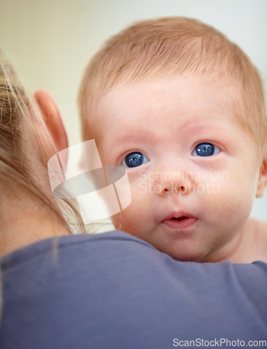 Image of Family, shoulder and face of baby with mother in home for bonding, loving relationship and affection. Love, bedroom and parent carrying newborn for child development, growth and care in nursery