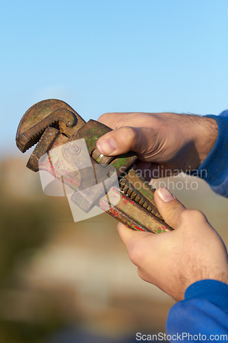 Image of Hand, mechanic and wrench tool closeup for maintenance or repair, helping or hardware. Man, spanner and engineer for car service job or improvement for fixing at garage, steel workshop for automobile