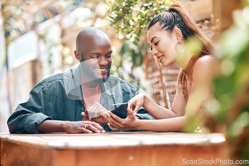 Image of Man, woman and showing of phone at restaurant, cafe or bistro with announcement on social media. Interracial couple, people or friends with mobile app with notification, promo or offer on internet