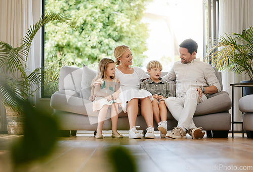 Image of Smile, happy and children with parents on a sofa relaxing in the living room of modern house. Bonding, love and young kids relaxing, resting and sitting with mother and father in the lounge at home.