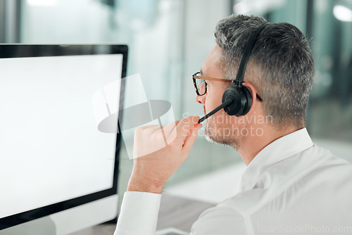 Image of Call center, man and mockup on computer, screen and customer service consulting from the back. Mature salesman, agent and desktop space for telemarketing, CRM advisory and FAQ contact for IT support