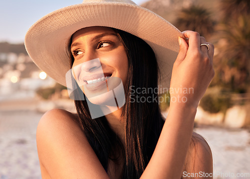 Image of Woman, hat and beach smile at sunset or holiday vacation, tropical ocean break or happy travel. Indian person, sea tip and destination in evening or summer sunshine in peace relax, quiet time as rest