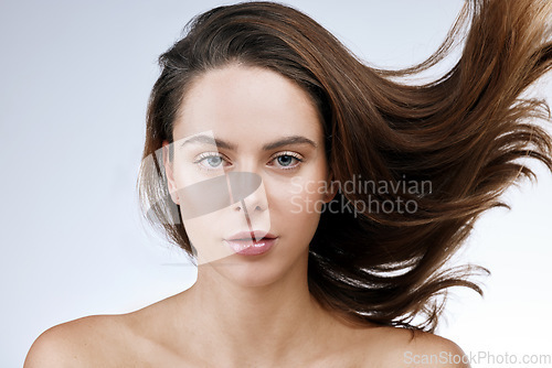 Image of Hair care, woman or portrait and beauty in studio with breeze, collagen treatment or brazilian for shine. Person, makeup and cosmetics with dermatology and keratin with white background for wellness