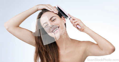 Image of Portrait, happy woman and brush for hair in studio for beauty mock up on white background. Female model, laugh and excitement for detangle, treatment and texture with styling tool for scalp health