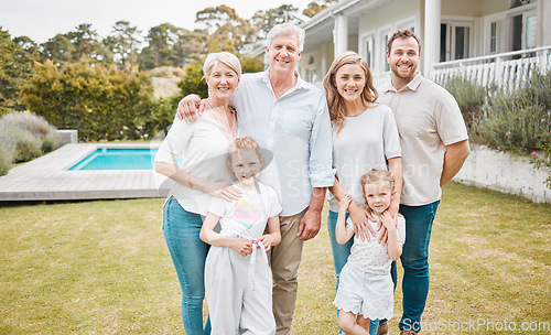 Image of Portrait, property and a family in the garden of their new home together for a visit during summer. Children, parents and grandparents in the backyard of an apartment for real estate investment