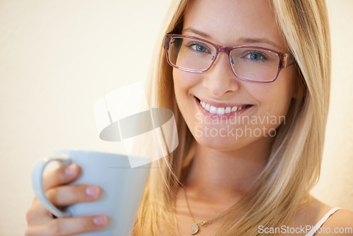 Image of Happy woman, portrait smile and coffee with glasses for morning, relax or satisfaction at home. Face of attractive female person, model or blonde with spectacles and cup of tea to start day at house