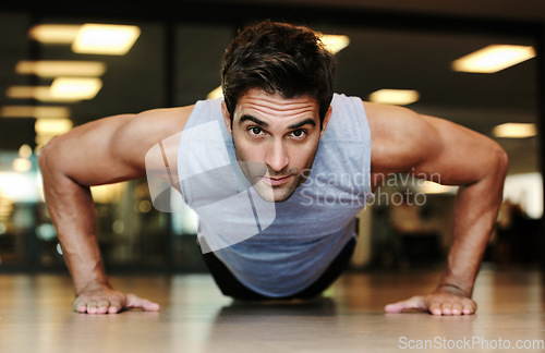 Image of Portrait, man and fitness with push up in gym for exercise in strength, health or wellness. Male person, alone and training on floor with workout routine for endurance, concentration and dedication