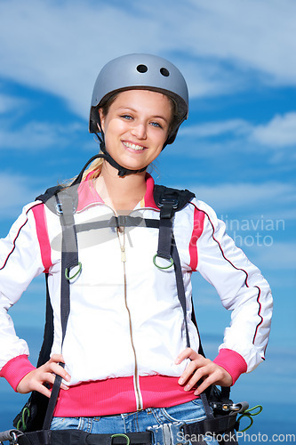 Image of Woman, skydiver and gear in outdoors, adventure and recreation or extreme sports for fun or equipment. Female person, travel and outside in portrait, holiday and vacation or getaway, active and smile