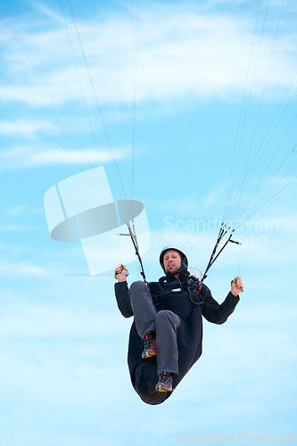 Image of Man, parachute and paragliding in air nature for exercise, healthy adventure with extreme sport. Athlete, glide or fearless for outdoor fitness for health wellness, helmet or safety gear by blue sky