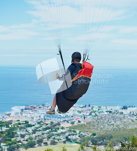 Image of Man, parachute or paragliding in blue sky for ocean view, flight freedom or adventure in extreme sport. Pilot, nature and fearless in outdoor fitness for health, sports and wellness with glide in air