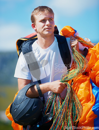 Image of Safety, parachute and man in nature for sport, equipment and strings for exercise for health support. Athlete, ready or training with fitness for outdoor wellness, helmet or harness in countryside