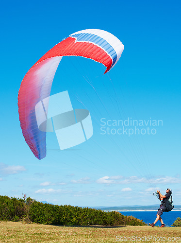 Image of Man, parachute and paragliding launch in nature with safety training, healthy adventure and extreme sport. Person, strings and flying skill for outdoor fitness with helmet and blue sky for wellness