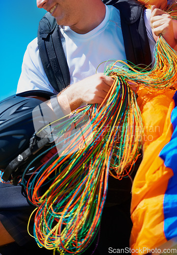 Image of Equipment, parachute or man in nature for sport, positive or strings for exercise for health support. Athlete, happy or training preparation with outdoor for wellness, helmet or summer in countryside