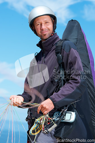 Image of Paragliding, parachute and man with portrait in nature in preparation, exercise or health support. Athlete, face or fitness for happy outdoor with safety harness, helmet or equipment in countryside