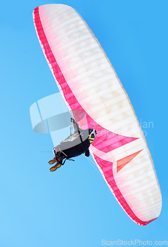 Image of Person, parachute or paragliding in air in nature, exercise or healthy adventure for extreme sport. Athlete, glide and fearless for outdoor fitness for wellness, below and safety gear by blue sky