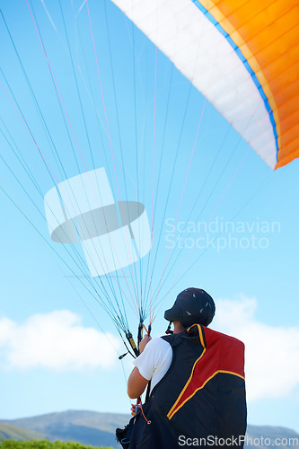 Image of Nature, sport or man with parachute in preparation, launch or paragliding training for adventure in extreme exercise. Person, balance or strings for outdoor fun or fitness with helmet or safety gear