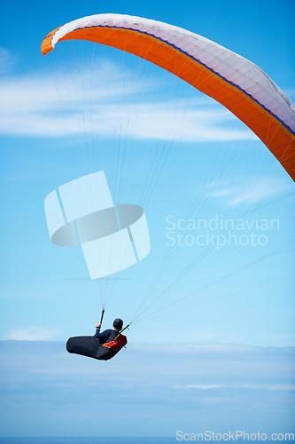 Image of Man, paragliding and blue sky adventure parachute in clouds for explore city, outdoor courage or fearless athlete. Male person, safety equipment for landing flying in nature sport, activity in wind