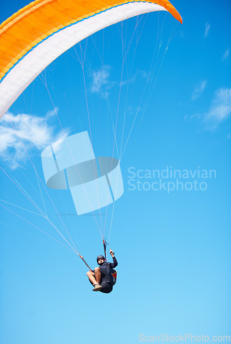 Image of Man, paragliding and blue sky adventure fun in clouds for explore city, outdoor courage or fearless athlete. Male person, parachute and mockup space or safety equipment for landing, flying in nature