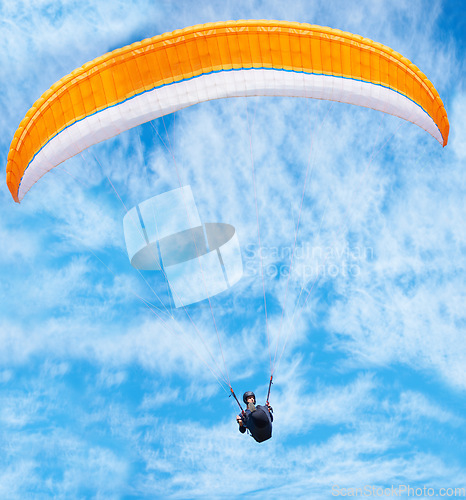 Image of Man, paragliding and blue sky adventure in clouds for explore city, outdoor courage or fearless athlete. Male person, parachute and air wind fun or safety equipment for landing, flying fit in nature