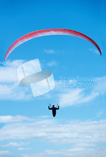 Image of Person, parachute and paragliding in blue sky in air, nature for exercise with healthy adventure for extreme sport. Athlete, flight or fearless by outdoor fitness for wellness, helmet or safety gear