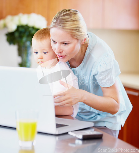 Image of Woman, baby and laptop for showing in home for learning, playing on streaming online. Mother, little boy or love in bond for growth, development or milestone with skills for technology in kitchen