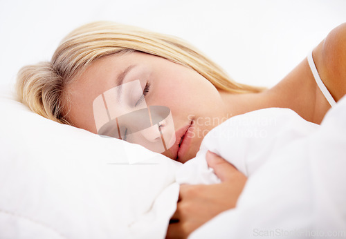Image of Woman, eyes closed and sleeping on bed in home for good sleep, relaxed or dream in closeup. Girl, hairstyle and face with peaceful, calm or expression with pyjamas on mattress for comfort on weekend