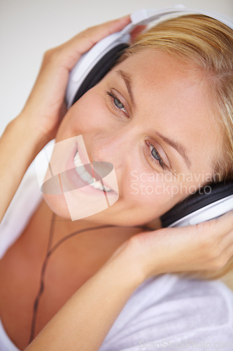 Image of Happy woman, smile and headphones for listening of music, freedom and wireless for fun in closeup. Female person, face and excitement for technology with podcast, radio or streaming service for relax
