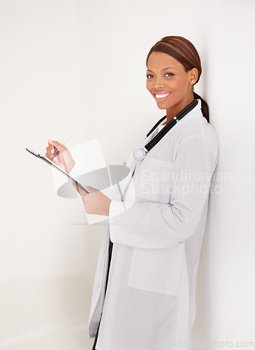 Image of Doctor portrait, woman with folder and writing in medical documents, report or information of patient history in clinic. Happy healthcare worker with hospital charts or checklist on a wall background