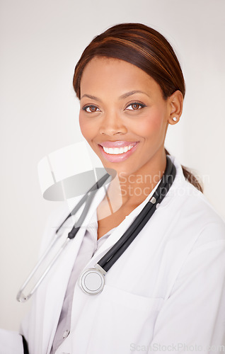 Image of Happy black woman, portrait and professional doctor smile in healthcare expert against a studio background. Face of African female person, surgeon or medical consultant in clinic, health and wellness