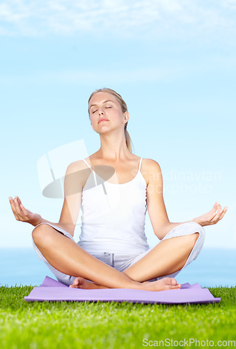 Image of Woman, yoga and meditation in park for peace, calm and mental health or wellness and mindfulness. Young and zen person relax with outdoor lotus pose, spiritual care and chakra on blue sky background