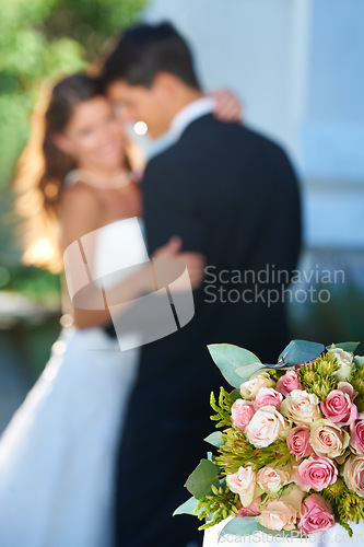 Image of Flower bouquet, happy couple and blurred embrace at wedding with love, smile and commitment at reception. Roses, woman and man hugging at marriage celebration event, partnership and future together.