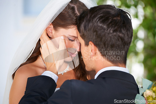 Image of Married couple, kiss and love at wedding for affection, marriage or romance together at outdoor ceremony. Man and woman in care, embrace or compassion for commitment, trust or loyalty in nature