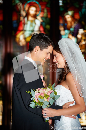Image of Happy couple, wedding and love at church for marriage, affection or commitment together at ceremony. Married man and woman touching foreheads with bouquet of roses or flowers in romantic relationship