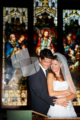 Image of Happy couple, hug and wedding at church for marriage, love or vow in commitment together. Married man or groom hugging woman or bride with smile for embrace, loyalty or support in trust at ceremony