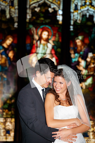 Image of Happy couple, hug and wedding in church for marriage love or vow in commitment together. Married man or groom hugging woman or bride with smile for embrace, loyalty or support in trust at ceremony