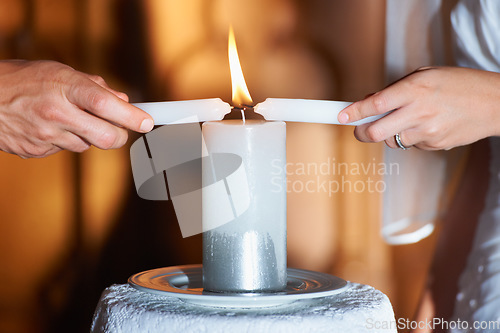 Image of Couple, hands and candle at wedding for unity, love and commitment at church or ceremony with closeup. Marriage, man and woman with light for trust, relationship and faith with bride and groom
